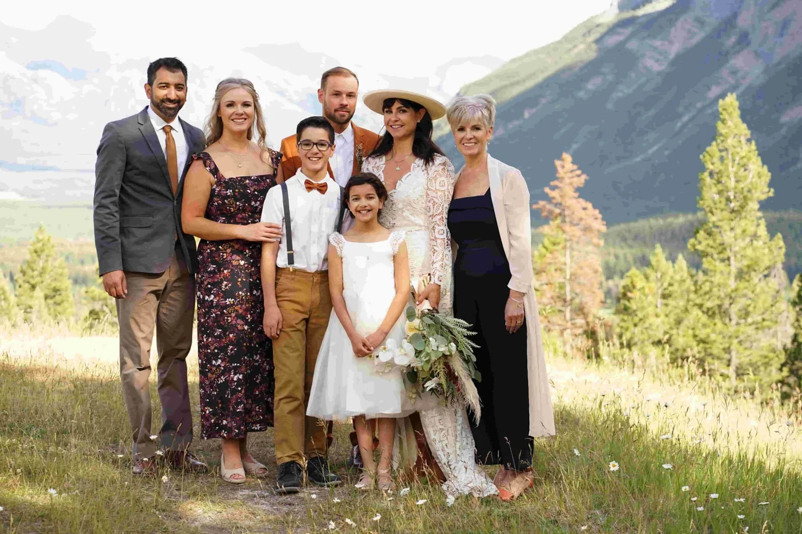 Extended family gathered for a portrait on a mountain hillside